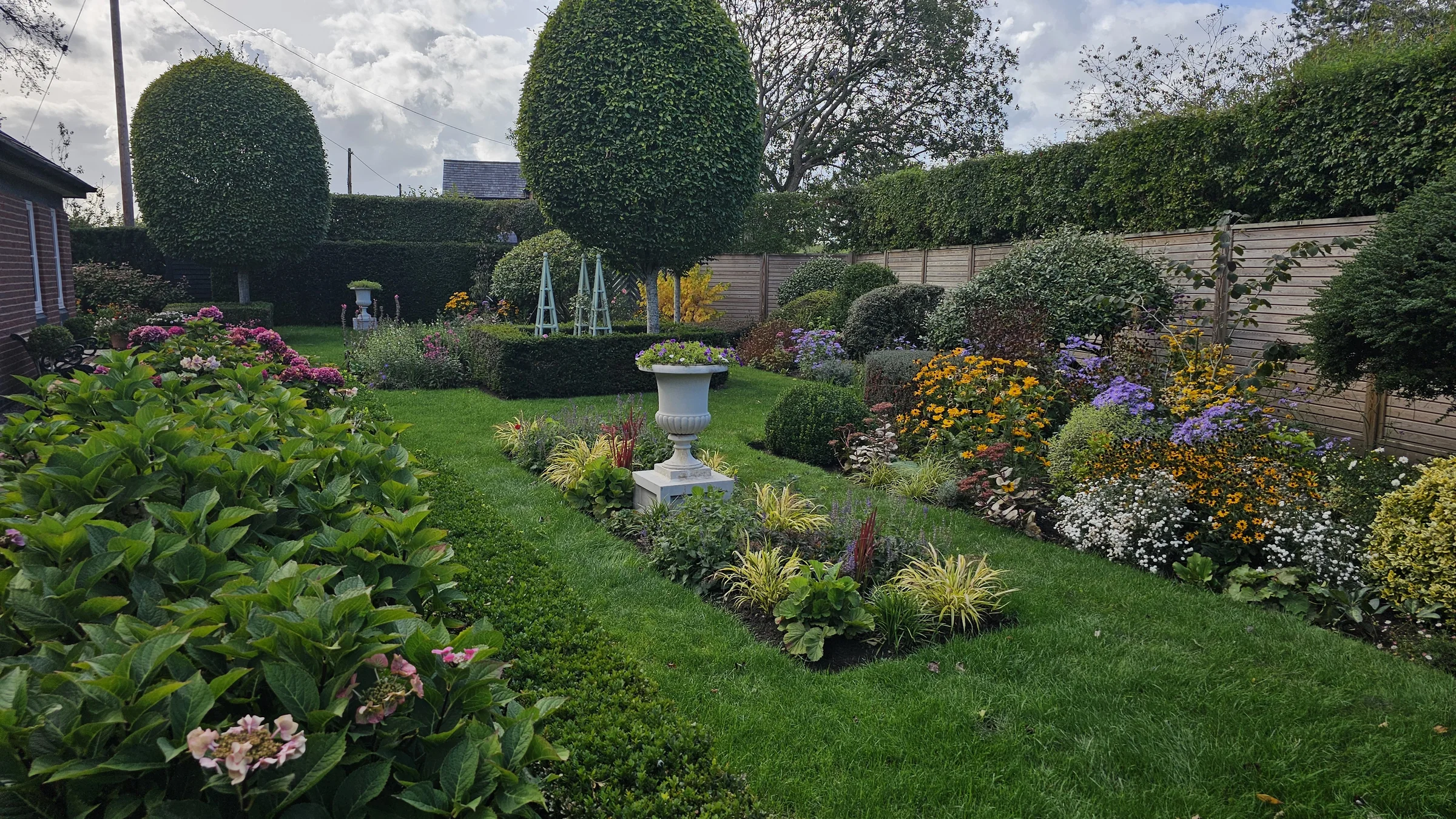 Established garden with layered borders and clipped evergreens